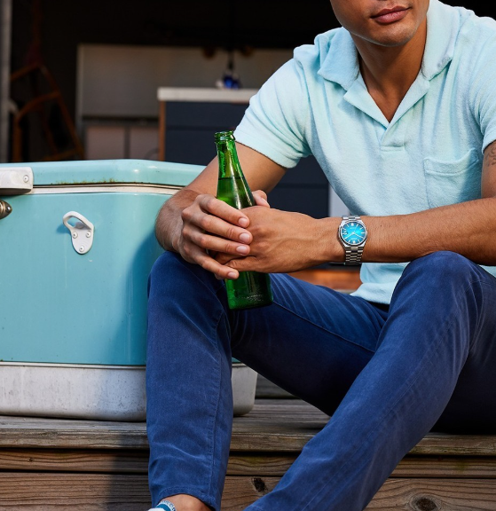 Man holding wrapped gift that is wrapped jewelry.