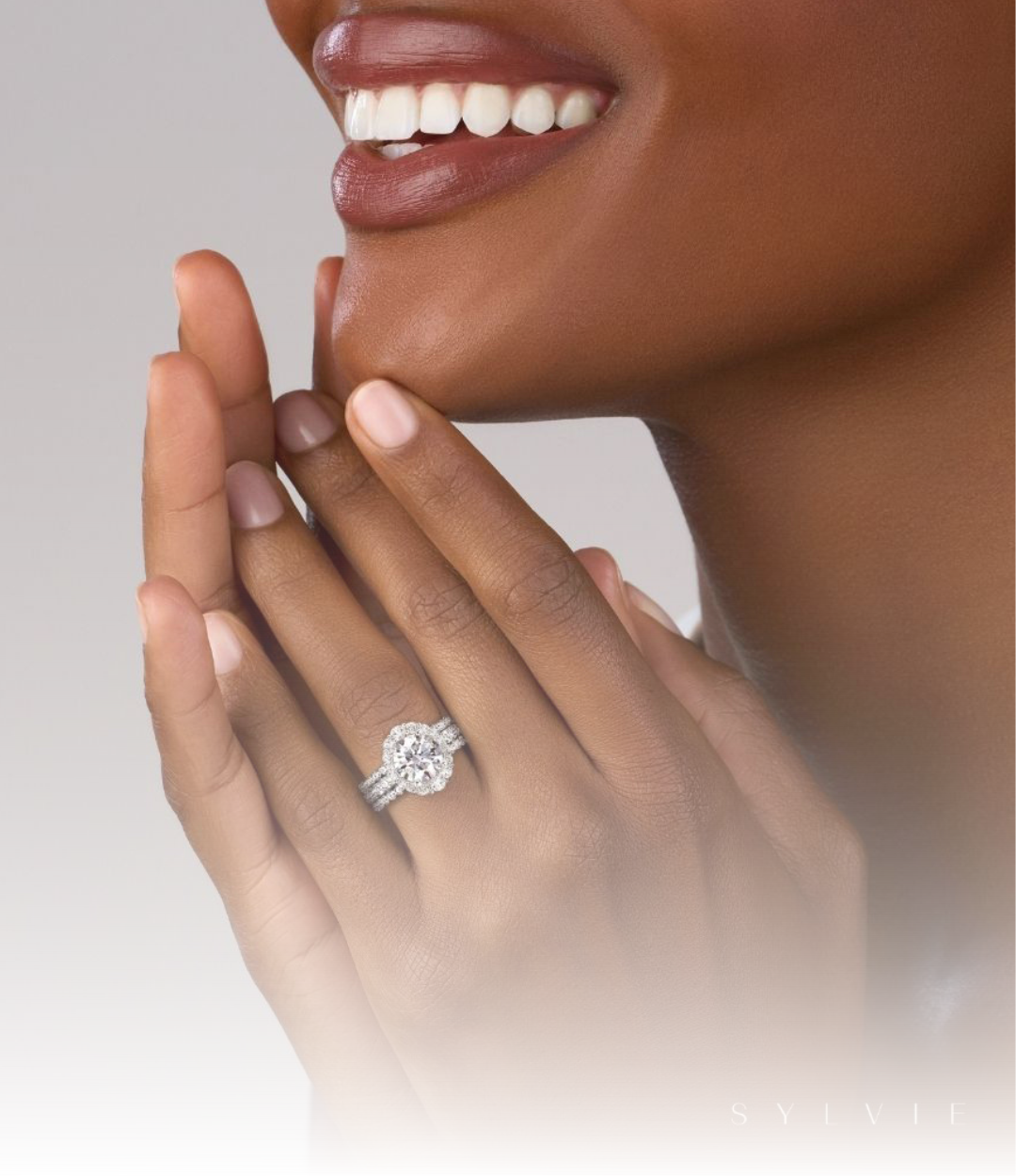 Image of woman wearing beautiful engagement ring and wedding bands.